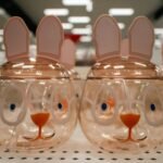 Easter bunny-shaped jars are lined up in a store.